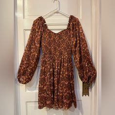 This Size Small Angie Dress Is Nwt, Has A Smocked Bodice,Long Sleeves, And A Lovely Sweetheart Neckline. It’s Light And Flowy And The Skirt Is Lined. Measures 33” From Shoulder To Hem. Brown Mini Dress For Fall, Flowy Brown Ruched Dresses, Fall Date Night Dress With Smocked Bodice, Fall Floral Print Smocked Dress For Brunch, Fall Brunch Mini Dress With Smocked Bodice, Fall Floral Smocked Dress For Brunch, Fall Date Night Dress With Smocked Back, Brown Smocked Bodice Midi Dress For Brunch, Brown Midi Dress With Smocked Bodice For Brunch