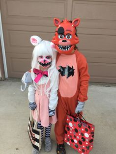 two children dressed up in costumes standing next to each other with shopping bags on their feet