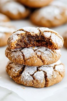 three cookies stacked on top of each other with powdered sugar and chocolate fillings