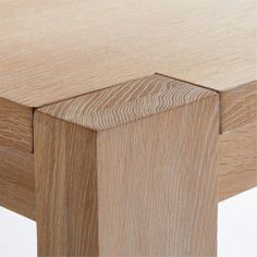 a close up view of the top of a table with wood grained edges and an angled edge