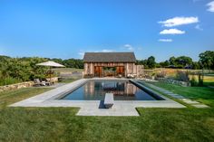 a pool in the middle of a grassy yard