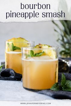 two glasses filled with pineapple smash on top of a table