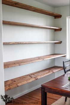 a wooden table and some shelves in a room