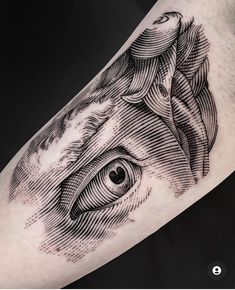 a black and white photo of a horse's eye on the forearm tattoo design