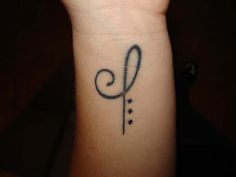 a small tattoo on the wrist of a woman