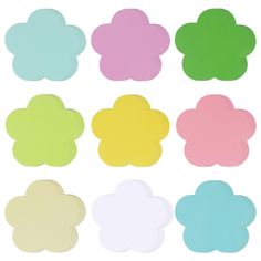 various colors of paper flowers on a white background