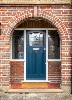 a blue front door on a brick building