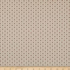 a white and brown fabric with small red stars on the side, in front of a ruler