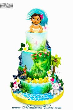 a three tiered cake decorated with an image of the little mermaid