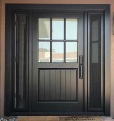 a black front door with glass and sidelights