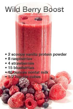 a blender filled with raspberries and blueberries next to it's contents