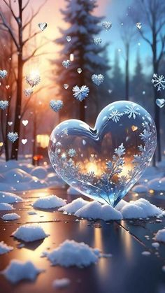 a heart shaped glass sitting on top of snow covered ground