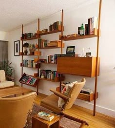 a living room filled with furniture and bookshelves