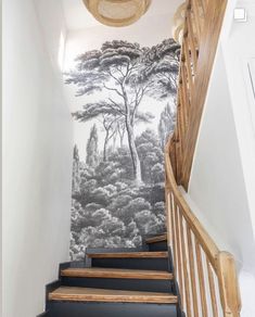 the stairs are lined with black and white wallpaper