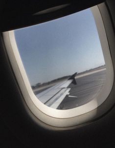 an airplane window looking out at the runway