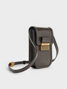 Step away from your black bag comfort zone with this mini Charlot crossbody bag in dark moss. It retains all the signature elements of the original classic, including sleek rounded corners, the distinctive ribbed push-lock closure, and a versatile crossbody strap. With just enough space for your phone and a few essentials, this new-season Charlot bag is ideal for quick errands or a fun night out. Charles Keith, Black Bag, Comfort Zone, Crossbody Strap, Rounded Corners, Night Out, Crossbody Bag, Pouch, Sleek