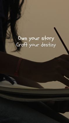 a person writing on a notebook with a pen in their hand and the words own your story craft your destiny