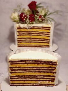 two slices of cake on plates with flowers in the middle and one slice missing from it