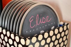 a stack of plates with the word elsie written on them in pink ink and black polka dots