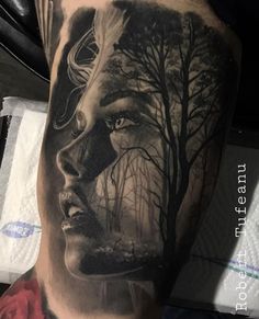 a woman's face with trees in the background on a man's leg