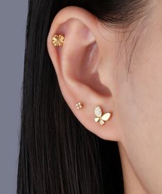 a close up of a person's ear with two small flowers on the side