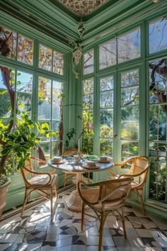 a dining room filled with lots of windows next to a potted plant on top of a table