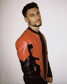 a man wearing a red and black leather jacket