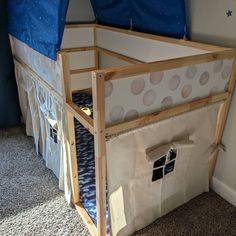 a child's bed with a tent on top