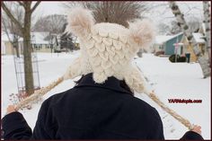 a person with a hat on their head in the snow