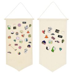 two white wall hangings with various stickers on them