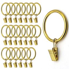 a bunch of gold colored metal rings and hooks on a white background with clippings