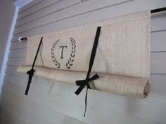 the monogrammed curtain valance is hung on the house's exterior wall