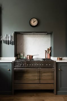 a kitchen with wooden floors and gray walls