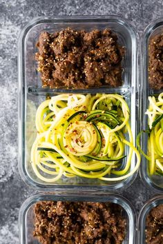 four glass containers filled with different types of food in each one, including zucchini noodles and meat