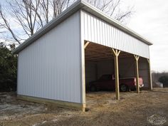 a large white building sitting in the middle of a field