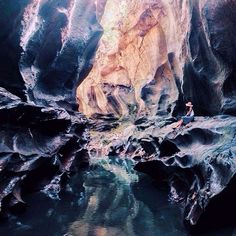 a person standing in the middle of a cave