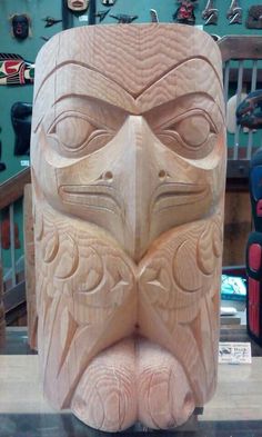 a carved wooden mask sitting on top of a table next to other woodworking tools