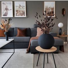 a living room filled with furniture and pictures on the wall