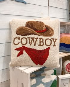 a cowboy pillow sitting on top of a wooden bench