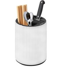 a white cup with spoons and utensils in it on a white background