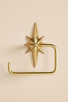 a gold metal towel ring with a star on it