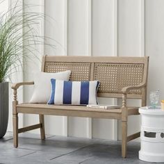 a wooden bench sitting next to a potted plant