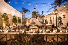 an outdoor dining area with tables and chairs set up for a formal function at night