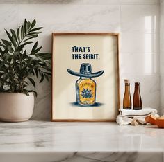 a framed poster with an image of a man's hat on it next to some bottles