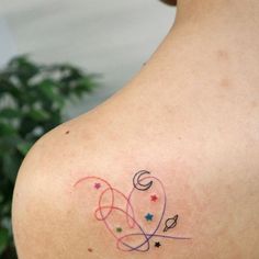 a woman with a tattoo on her shoulder and the word love is written in small stars