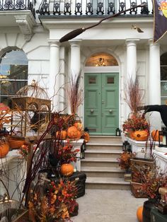 a house with pumpkins and other decorations on the front steps