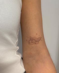 a woman with a small tattoo on her arm