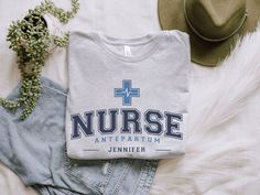 the nurse shirt is next to jeans and a hat