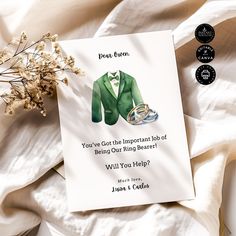 a card with an image of a green suit and shoes on it next to flowers