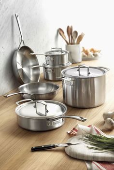 several pots and pans on a wooden table